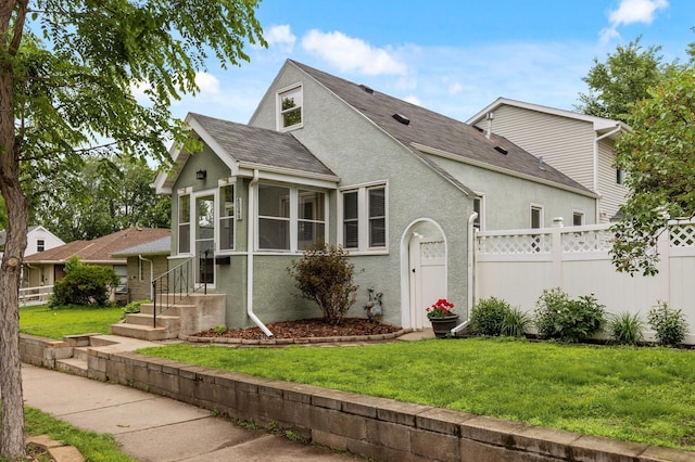 6049 Wentworth Ave, Minneapolis, MN 55419 - view of front of home with roof with shingles, stucco siding, and a sunroom