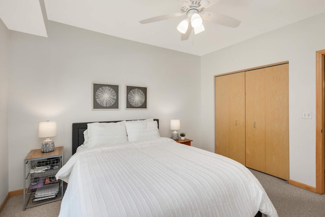 bedroom featuring light colored carpet, a closet, baseboards, and ceiling fan