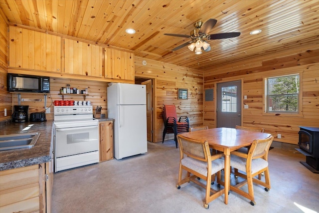 8494 Peary Junction Rd, Kelsey, MN 55724 - dining area featuring a wood stove, wooden ceiling, wood walls, a ceiling fan, and recessed lighting