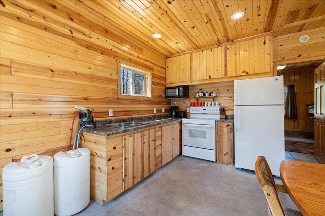 8494 Peary Junction Rd, Kelsey, MN 55724 - kitchen featuring white appliances, dark countertops, wooden walls, wooden ceiling, and light brown cabinets