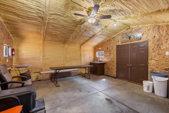 8494 Peary Junction Rd, Kelsey, MN 55724 - recreation room featuring concrete floors, a ceiling fan, lofted ceiling, and a desk