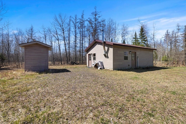 8494 Peary Junction Rd, Kelsey, MN 55724 - view of side of property with an outdoor structure and a lawn