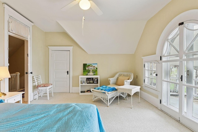 bedroom featuring light colored carpet, a ceiling fan, baseboards, and lofted ceiling