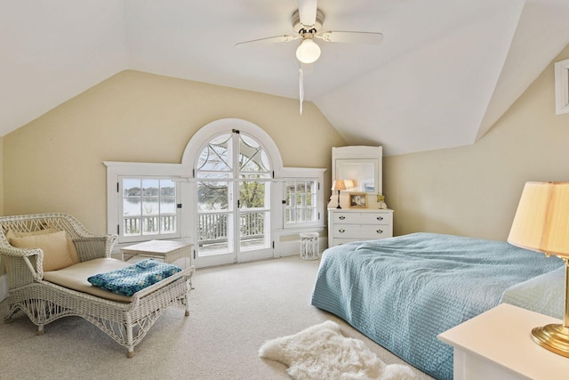 carpeted bedroom featuring a water view, access to outside, a ceiling fan, and vaulted ceiling