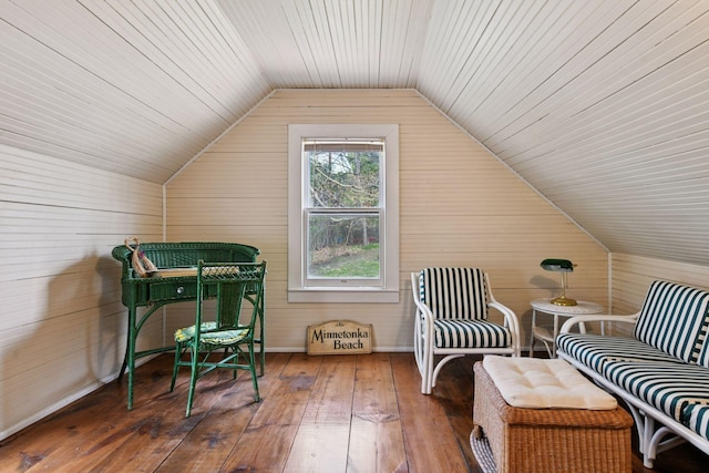 additional living space featuring hardwood / wood-style flooring, wood walls, wooden ceiling, and lofted ceiling