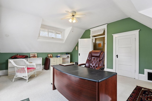 office space featuring a ceiling fan, baseboards, vaulted ceiling, and light carpet