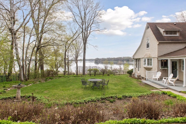 view of yard featuring a water view and a patio area