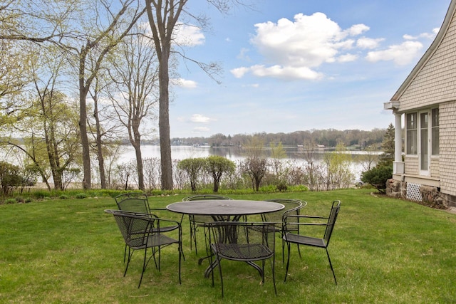 view of yard featuring outdoor dining area and a water view