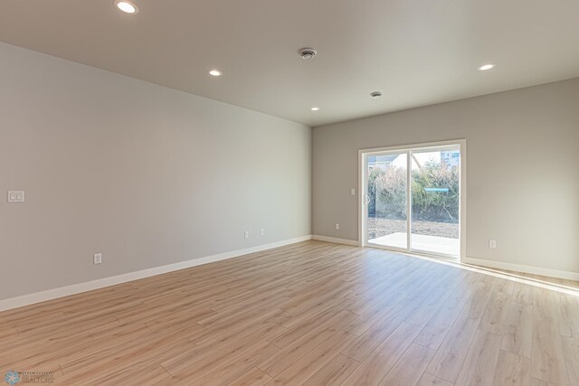 spare room featuring baseboards, recessed lighting, and light wood finished floors