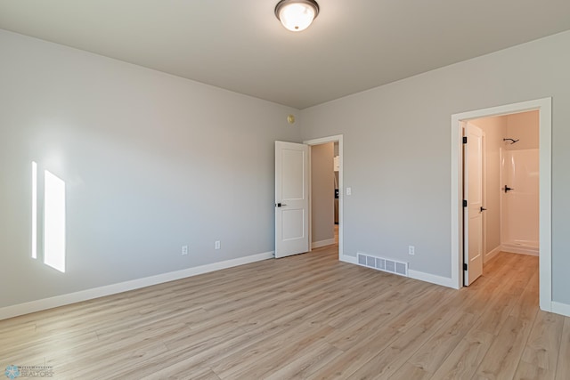 unfurnished bedroom with visible vents, baseboards, and light wood-type flooring