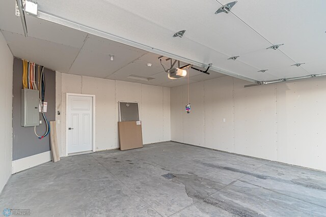 garage featuring electric panel and a garage door opener