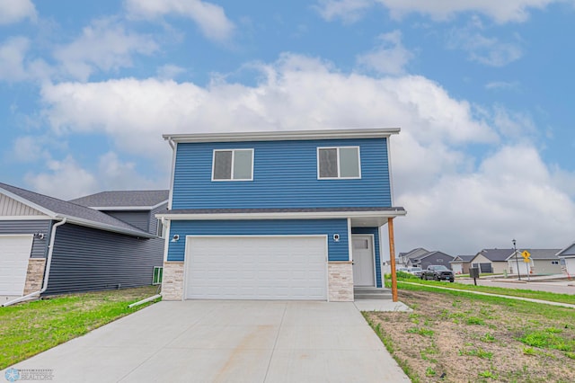 6760 66th Ave S, Horace, ND 58047 - view of front of house with driveway, an attached garage, stone siding, and a residential view