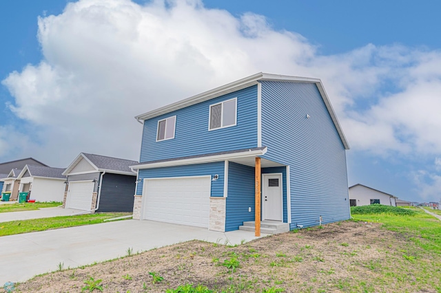 6760 66th Ave S, Horace, ND 58047 - view of front of house with driveway, a garage, and stone siding