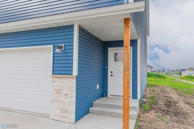 6760 66th Ave S, Horace, ND 58047 - entrance to property with a garage and stone siding