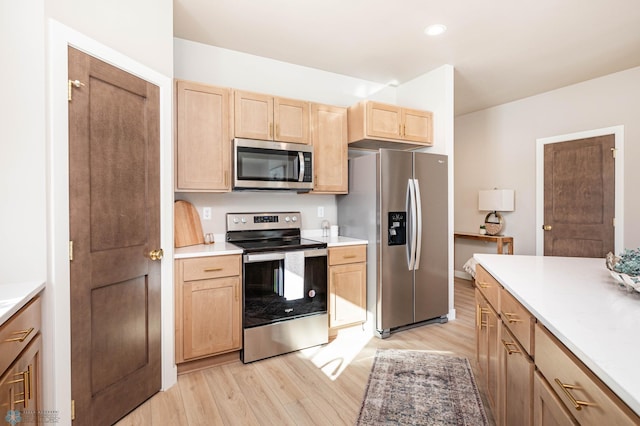 5862 Ellis Dr S, Horace, ND 58047 - kitchen with stainless steel appliances, light brown cabinetry, light wood finished floors, light countertops, and recessed lighting