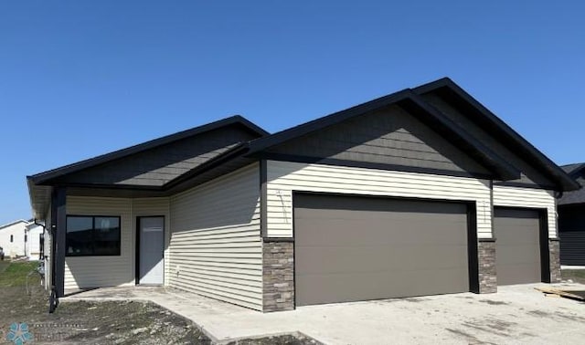 5862 Ellis Dr S, Horace, ND 58047 - view of front of property featuring a garage and stone siding