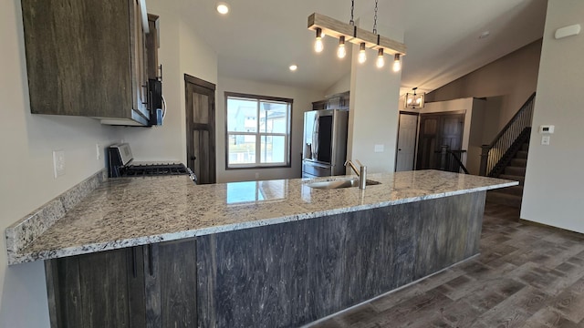 9972 14th Cir NE, Saint Michael, MN 55376 - kitchen featuring appliances with stainless steel finishes, vaulted ceiling, dark wood-style floors, dark brown cabinetry, and a peninsula