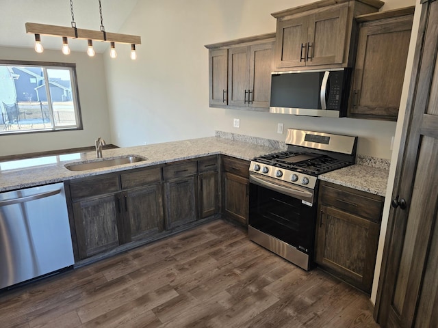 9972 14th Cir NE, Saint Michael, MN 55376 - kitchen with appliances with stainless steel finishes, dark brown cabinets, dark wood-style floors, light stone countertops, and vaulted ceiling