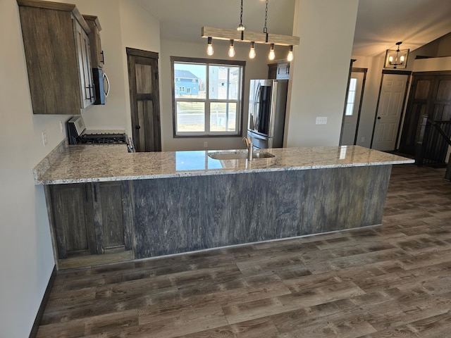 9972 14th Cir NE, Saint Michael, MN 55376 - kitchen with appliances with stainless steel finishes, dark wood-type flooring, light stone countertops, and a peninsula