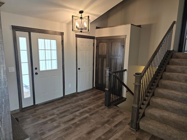 9972 14th Cir NE, Saint Michael, MN 55376 - entrance foyer featuring dark wood-style flooring, a chandelier, stairway, and lofted ceiling
