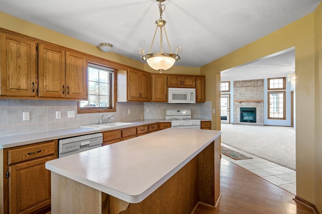 1904 Beebe Rd, Maplewood, MN 55109 - kitchen with white appliances, a sink, plenty of natural light, and light countertops