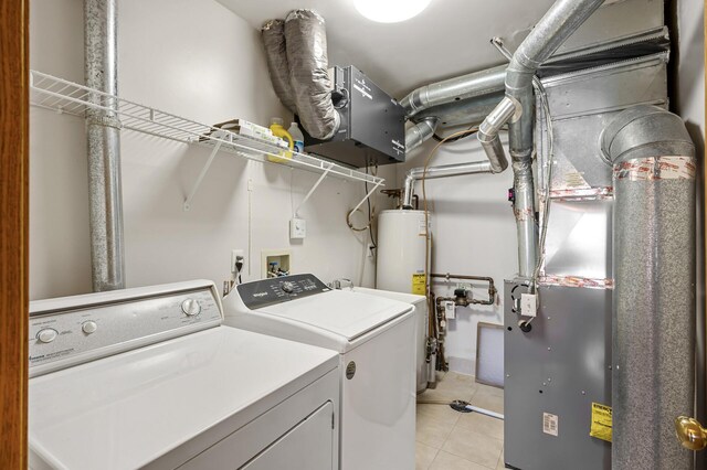1904 Beebe Rd, Maplewood, MN 55109 - laundry area with washer and dryer, light tile patterned floors, and water heater