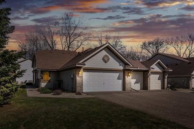1904 Beebe Rd, Maplewood, MN 55109 - view of front facade with driveway, a garage, a front yard, and brick siding
