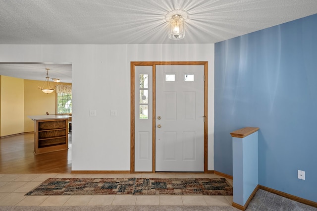 1904 Beebe Rd, Maplewood, MN 55109 - tiled foyer featuring baseboards and a textured ceiling