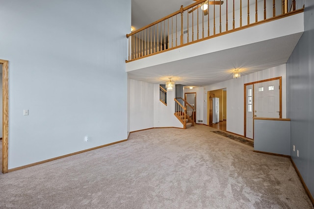 1904 Beebe Rd, Maplewood, MN 55109 - unfurnished living room with stairway, carpet, a towering ceiling, and baseboards