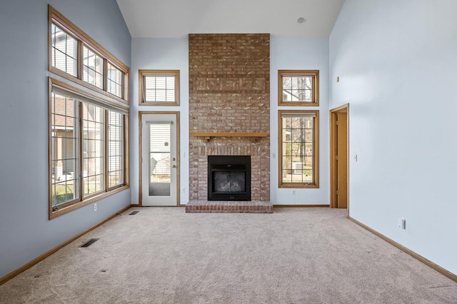 1904 Beebe Rd, Maplewood, MN 55109 - unfurnished living room with carpet, a high ceiling, plenty of natural light, and baseboards