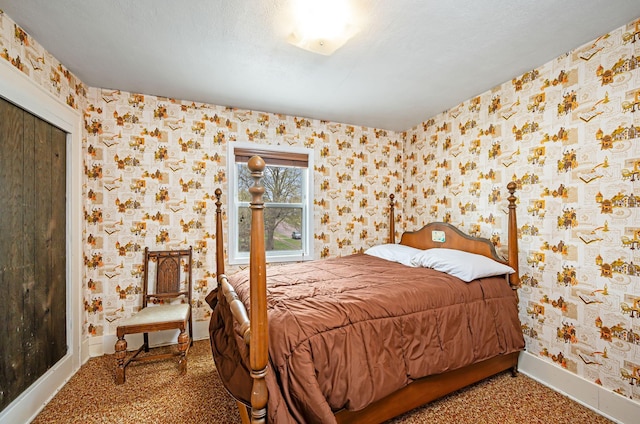 carpeted bedroom featuring baseboards and wallpapered walls