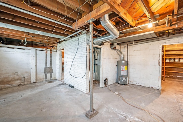 unfinished basement featuring gas water heater