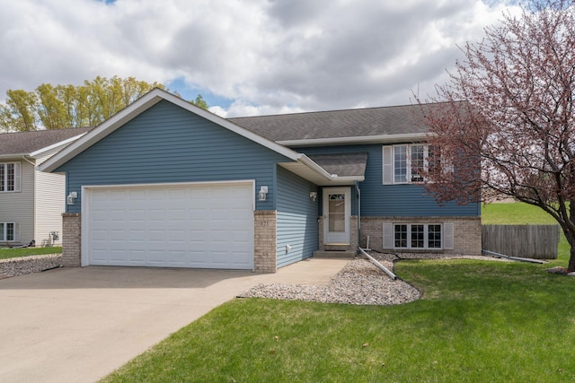 split level home featuring brick siding, an attached garage, a front yard, and concrete driveway