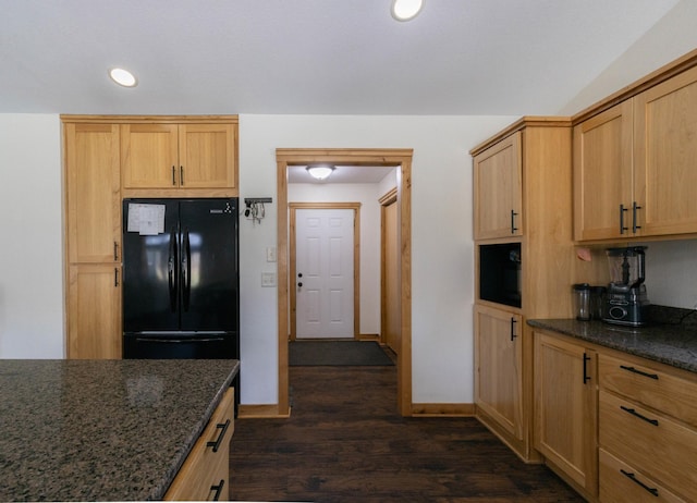 kitchen with freestanding refrigerator, dark wood-style floors, baseboards, recessed lighting, and dark stone countertops