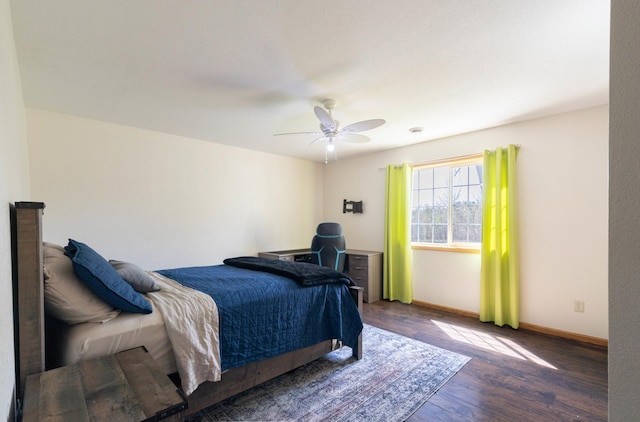 bedroom with wood finished floors, baseboards, and a ceiling fan
