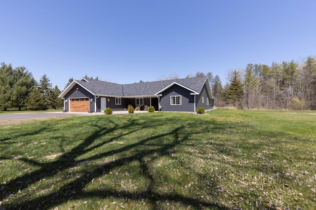 single story home with an attached garage, asphalt driveway, and a front lawn