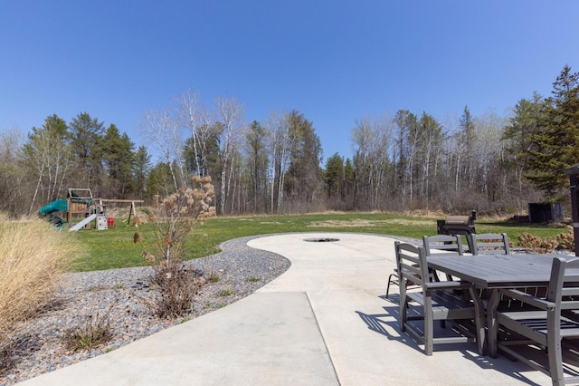 view of patio / terrace with a playground and outdoor dining space