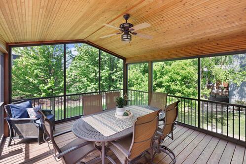 sunroom with a ceiling fan, lofted ceiling, and healthy amount of natural light