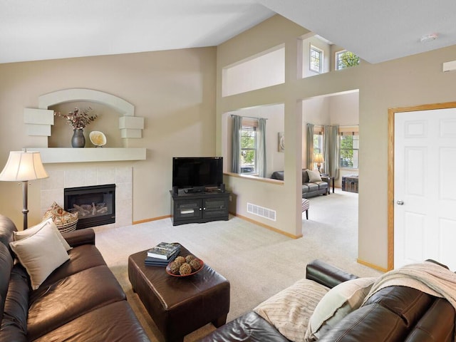 carpeted living area with a fireplace and baseboards