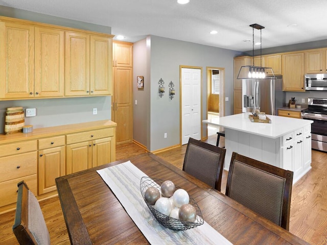 kitchen with stainless steel appliances, light wood-type flooring, recessed lighting, light brown cabinetry, and light countertops