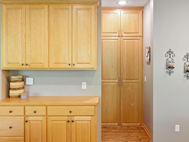 kitchen with light wood-style floors, light countertops, and light brown cabinetry