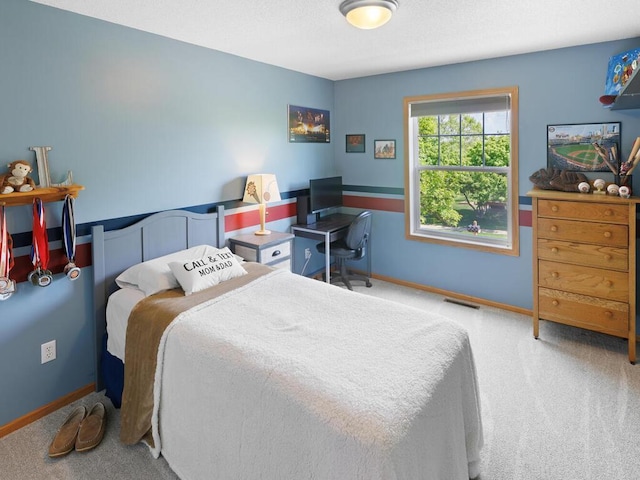 carpeted bedroom with baseboards