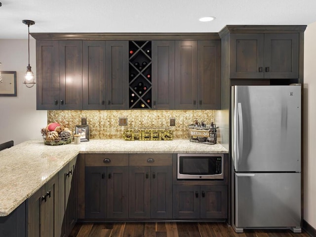 kitchen with stainless steel appliances, backsplash, dark wood finished floors, light stone counters, and recessed lighting