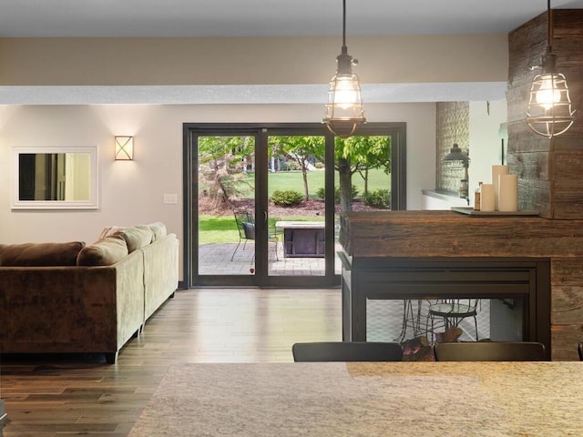 living area featuring wood finished floors and a large fireplace