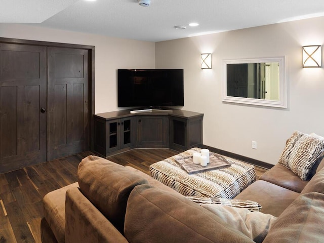 living room with dark wood finished floors, baseboards, and recessed lighting