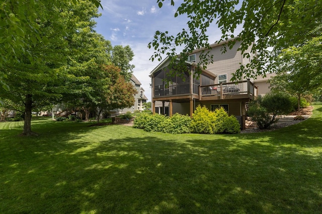 view of green lawn with a sunroom and a wooden deck