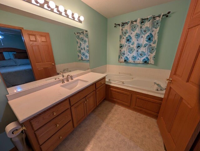 full bath featuring a garden tub and vanity