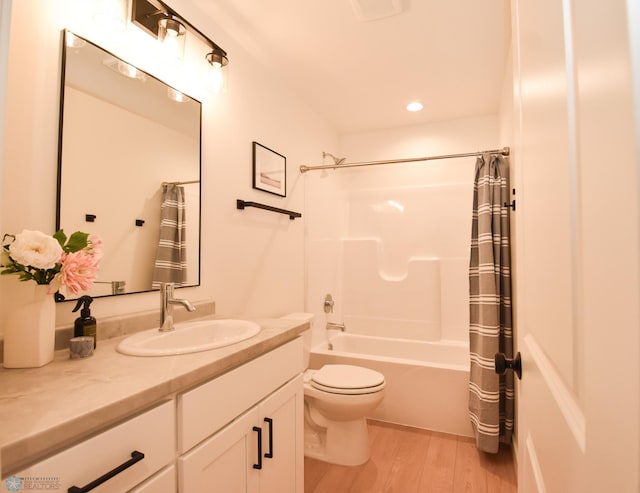 bathroom with vanity, wood finished floors, toilet, shower / bathtub combination with curtain, and recessed lighting