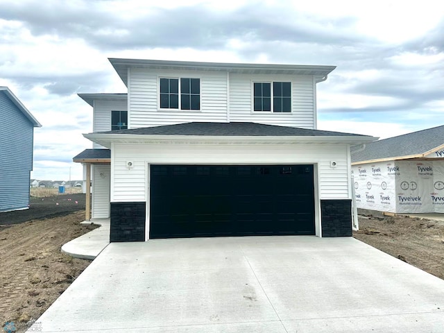6275 87th Ave S, Horace, ND 58047 - view of front facade with stone siding, an attached garage, and concrete driveway