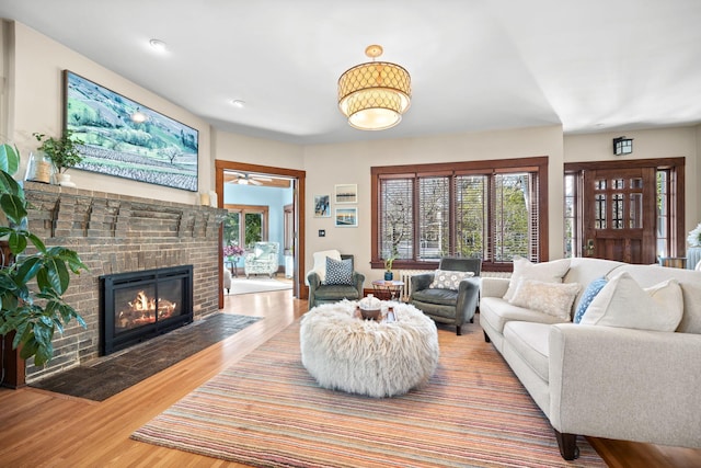 living room with a fireplace and wood finished floors